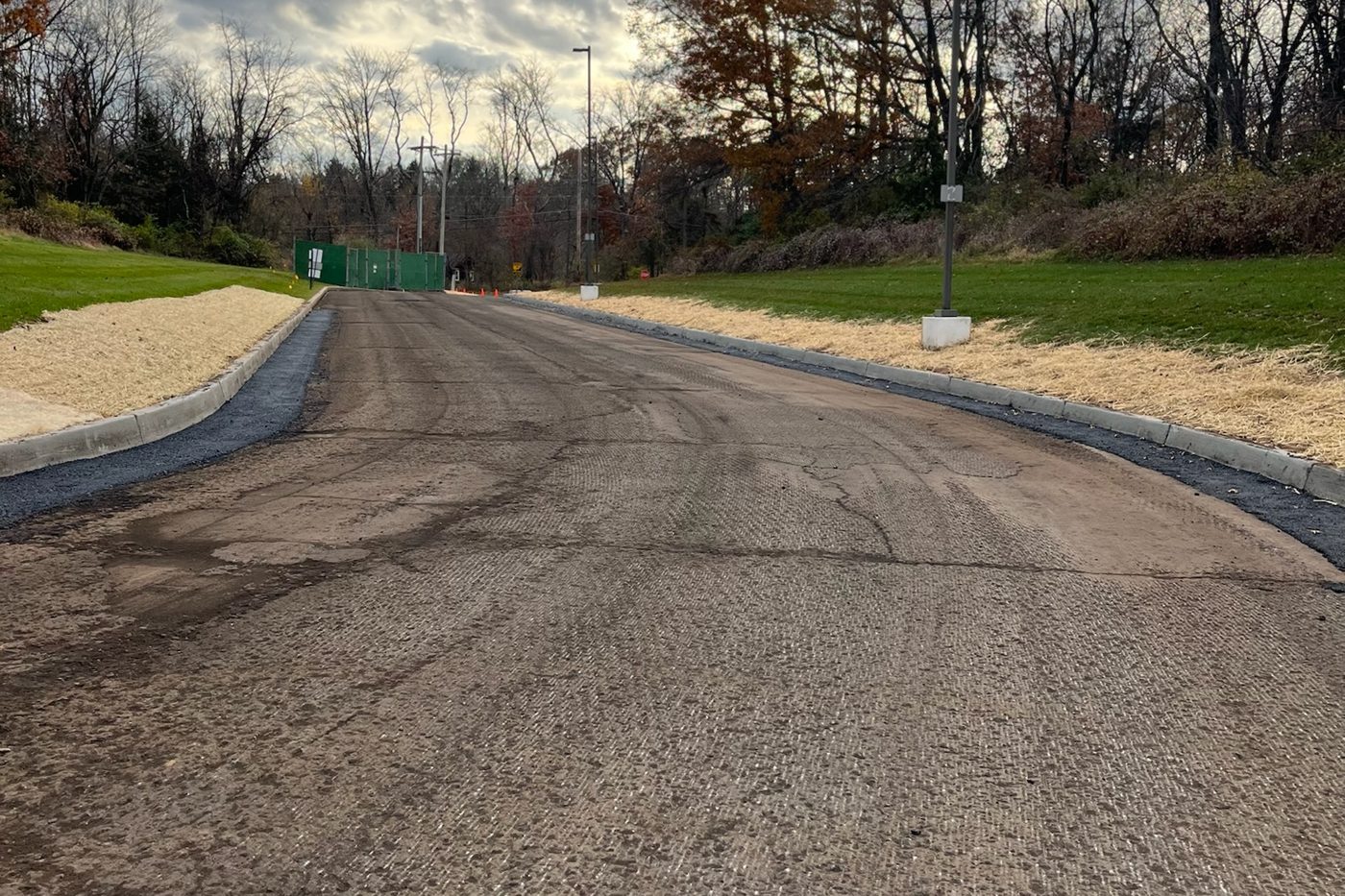 Commercial access road milled and curbed, base prepped for a fresh asphalt wearing course in NJ