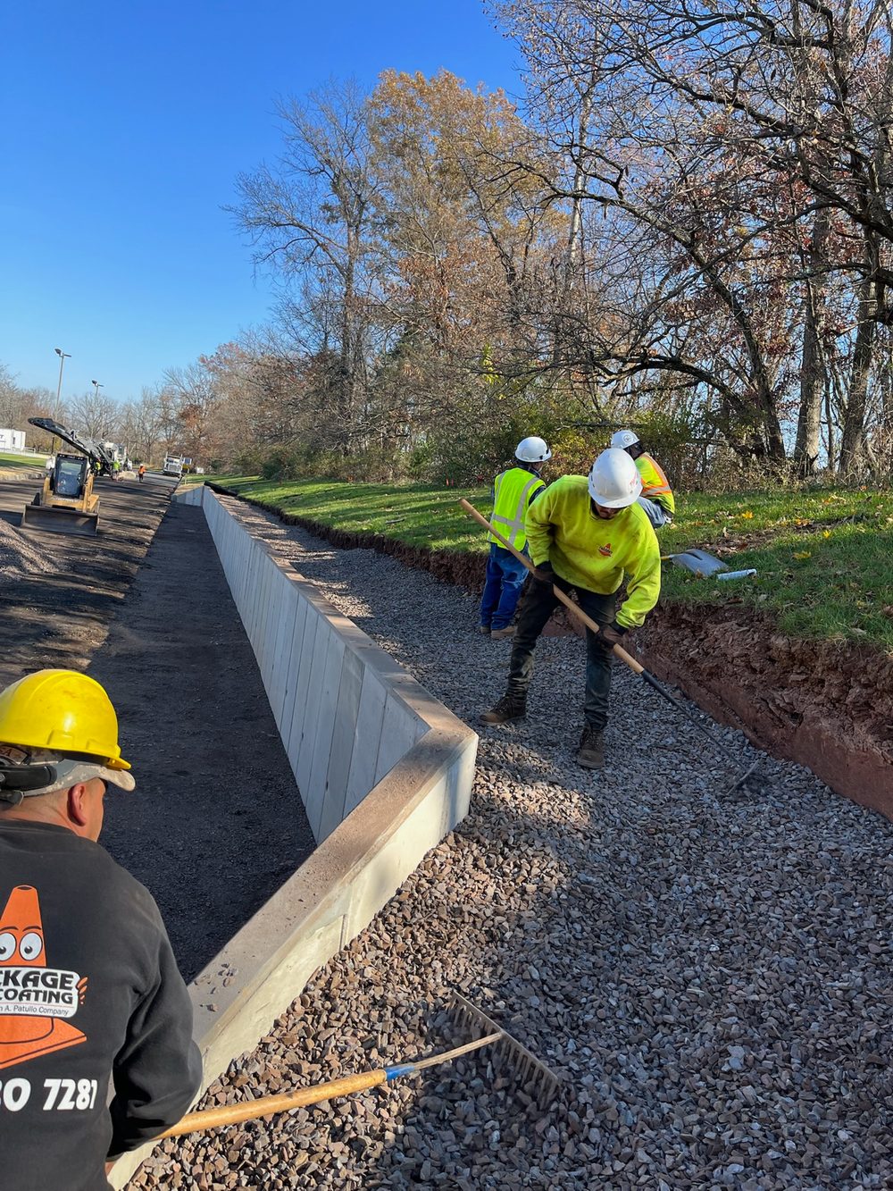 Finished cast-in-place concrete barrier curb along a commercial parking lot, installed by Beckage Sealcoating in New Jersey